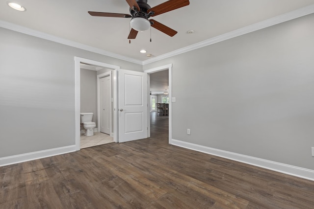 unfurnished bedroom with ensuite bathroom, ornamental molding, wood finished floors, and baseboards