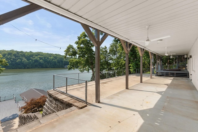 view of patio with ceiling fan and a water view