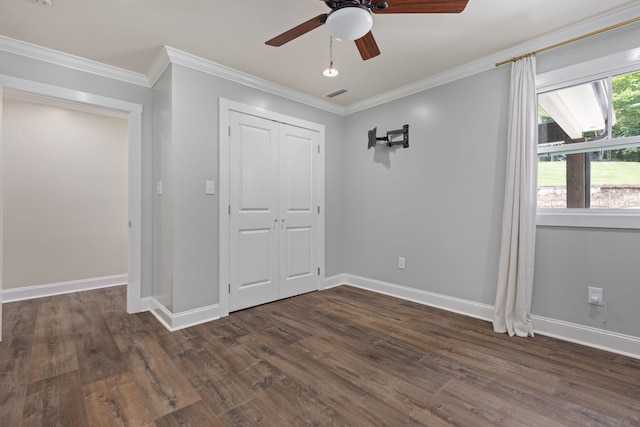 unfurnished bedroom featuring dark wood-style floors, baseboards, and ornamental molding