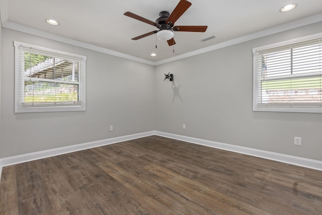 spare room with baseboards, visible vents, dark wood finished floors, and crown molding