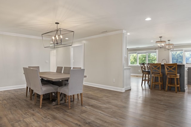 dining area with ornamental molding, dark wood-type flooring, and a healthy amount of sunlight