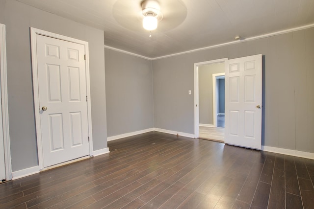 empty room featuring dark hardwood / wood-style flooring and crown molding