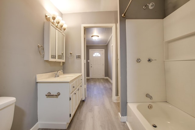 full bathroom with hardwood / wood-style flooring, vanity, toilet, and shower / bath combination