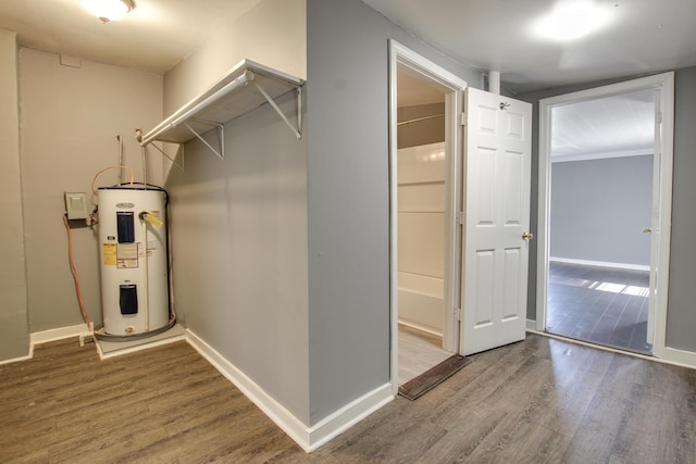 interior space with hardwood / wood-style flooring and water heater