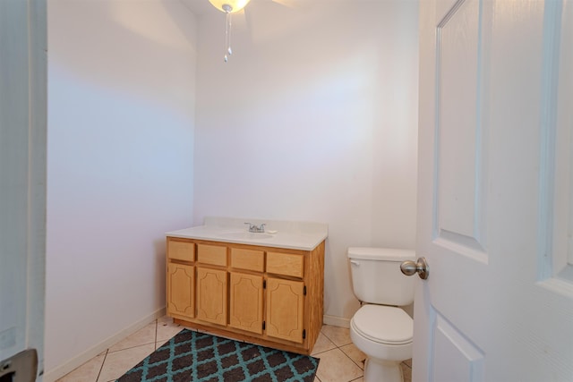 bathroom with ceiling fan, tile patterned flooring, vanity, and toilet