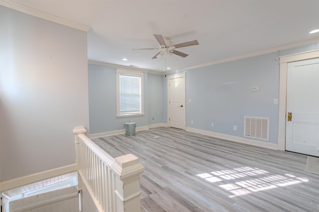 unfurnished room with light hardwood / wood-style floors, ceiling fan, and ornamental molding