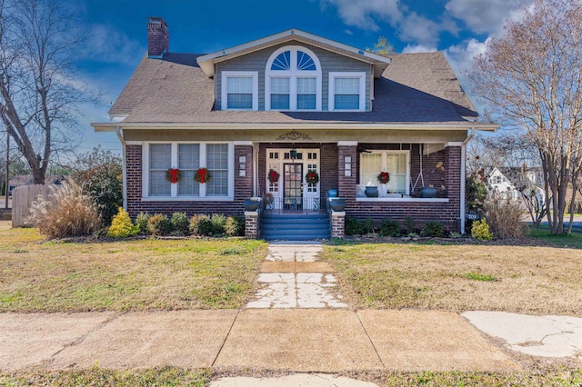 view of front of home featuring a porch and a front lawn