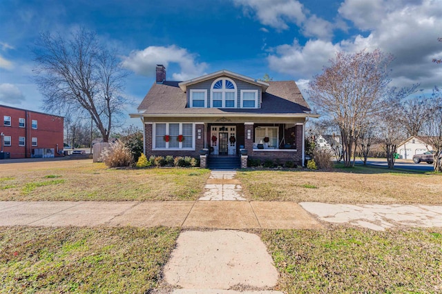 bungalow with a porch and a front yard