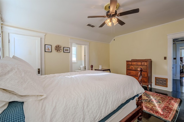 bedroom featuring ceiling fan, lofted ceiling, and ensuite bathroom