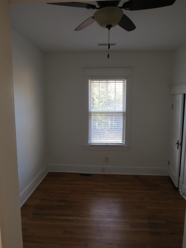 spare room with dark hardwood / wood-style floors and ceiling fan