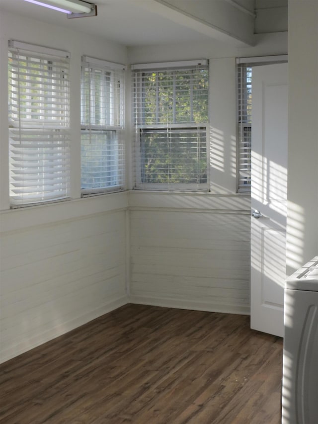 unfurnished room featuring washer / clothes dryer and dark wood-type flooring