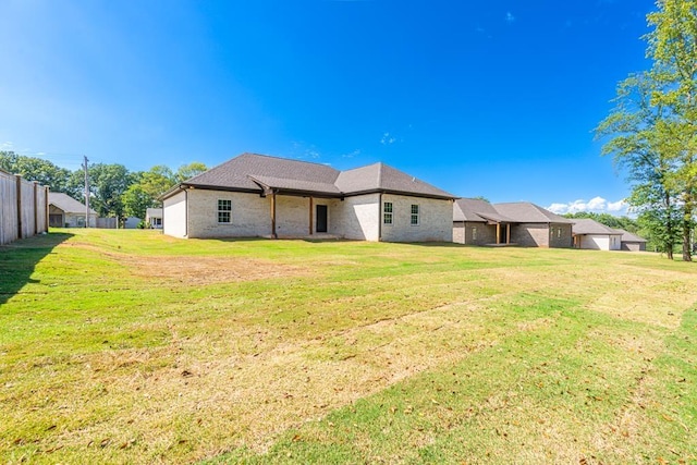 back of house featuring a yard