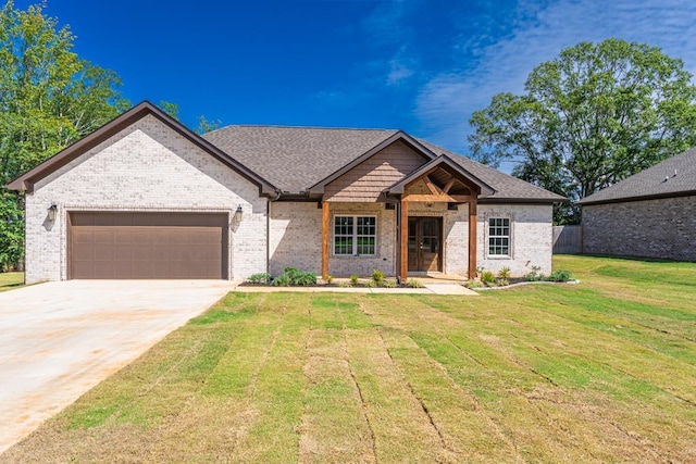 view of front of property with a garage and a front lawn