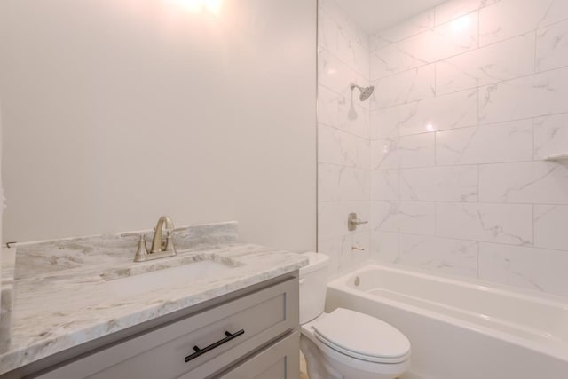 full bathroom featuring tiled shower / bath combo, vanity, and toilet