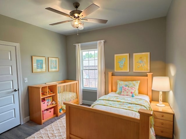 bedroom featuring dark hardwood / wood-style floors and ceiling fan