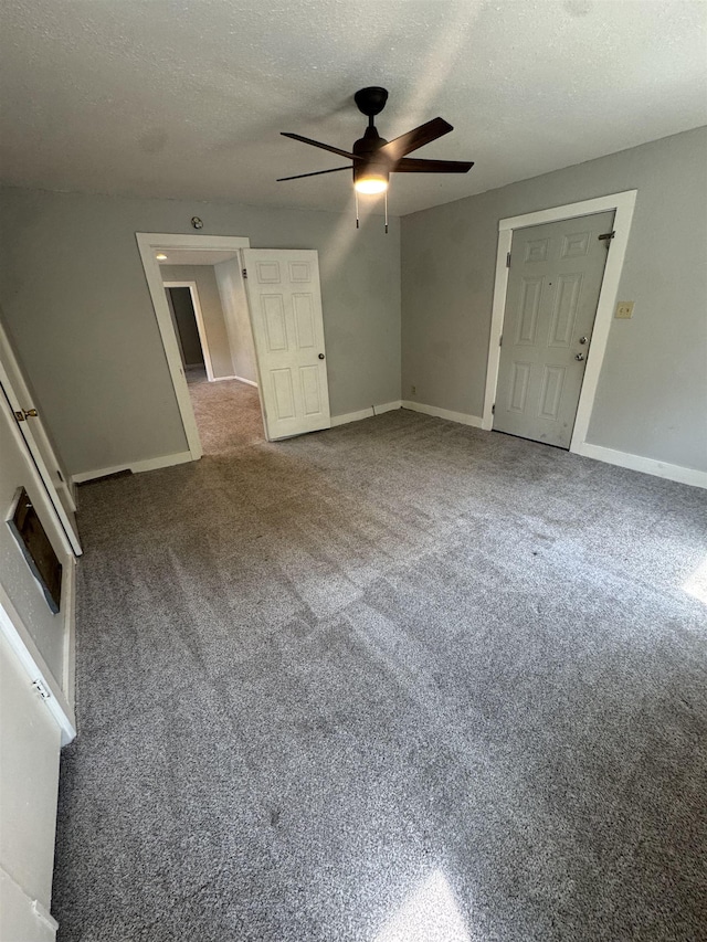  - carpeted empty room with a ceiling fan and a textured ceiling