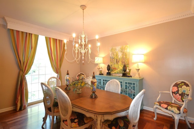 dining area with hardwood / wood-style floors, an inviting chandelier, and crown molding