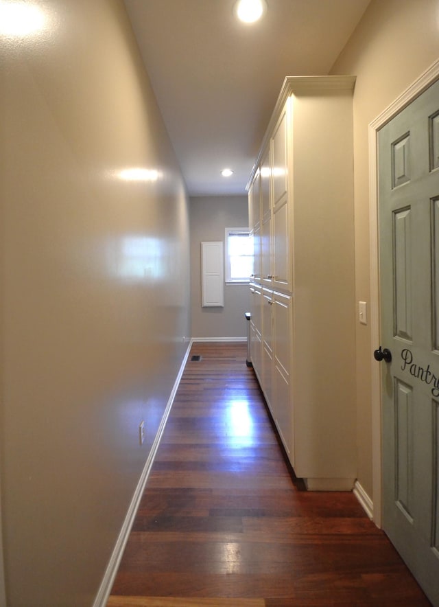 corridor with dark hardwood / wood-style flooring