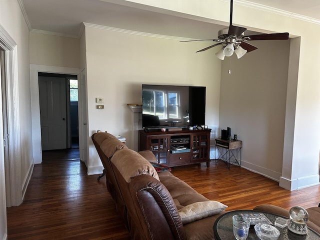 living room with dark hardwood / wood-style floors, ceiling fan, and crown molding