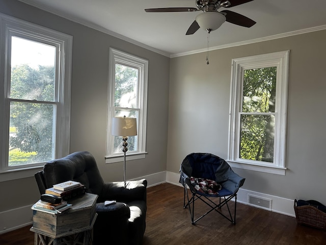 sitting room with dark hardwood / wood-style flooring, ceiling fan, and ornamental molding