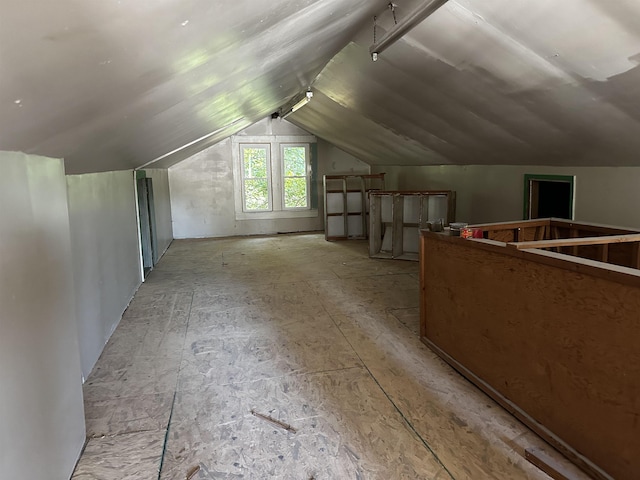 additional living space featuring lofted ceiling