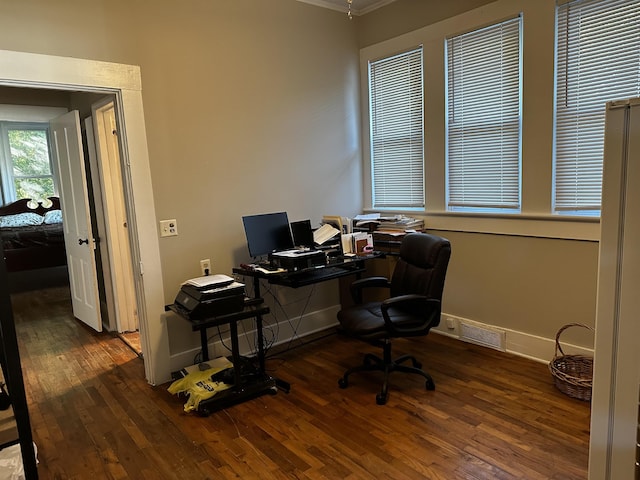 office with crown molding and dark wood-type flooring