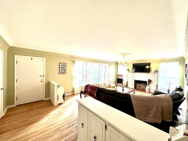 living room with an inviting chandelier and light hardwood / wood-style floors