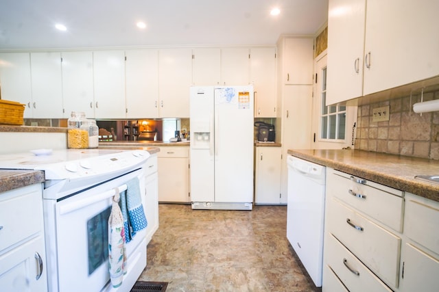 kitchen with tasteful backsplash, white cabinets, and white appliances