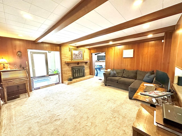 living room with beamed ceiling, carpet flooring, a fireplace, and wood walls