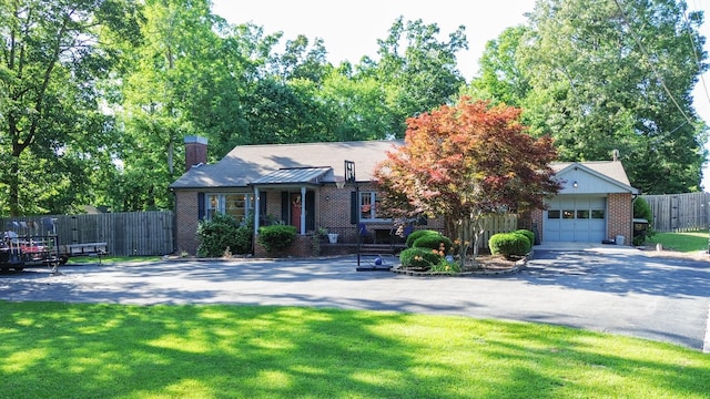 view of front of house with a garage and a front lawn