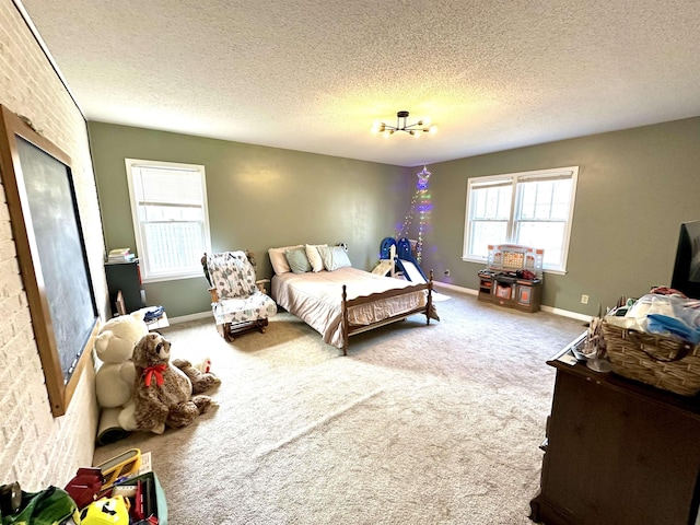 carpeted bedroom featuring a textured ceiling