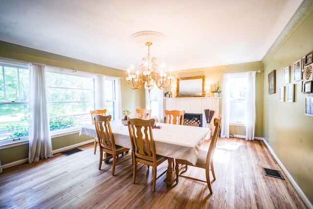 dining area featuring light hardwood / wood-style floors and a notable chandelier