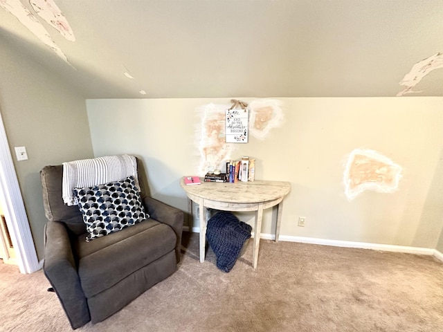 sitting room featuring vaulted ceiling and carpet