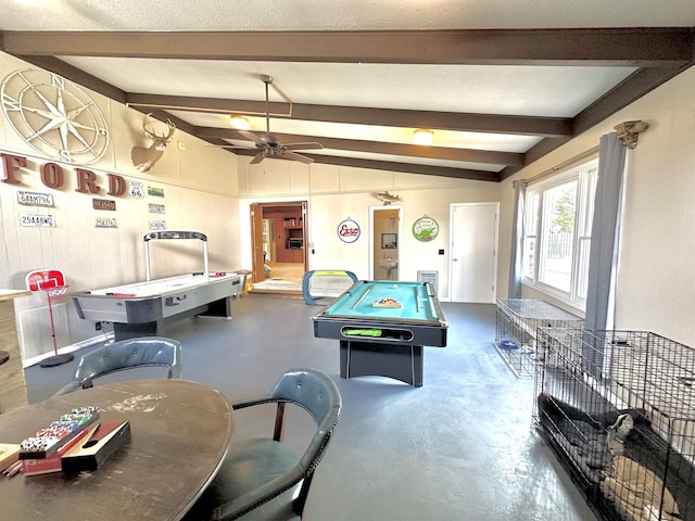 recreation room featuring vaulted ceiling with beams, concrete flooring, and ceiling fan