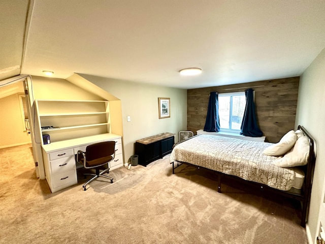 carpeted bedroom with vaulted ceiling and wood walls