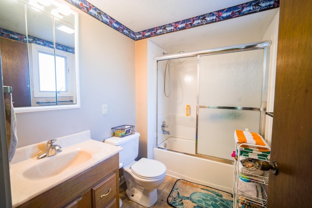 full bathroom with vanity, combined bath / shower with glass door, a textured ceiling, and toilet