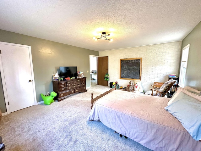 bedroom with light colored carpet and a textured ceiling