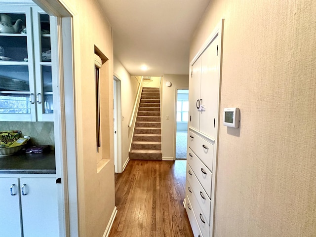 corridor with hardwood / wood-style floors