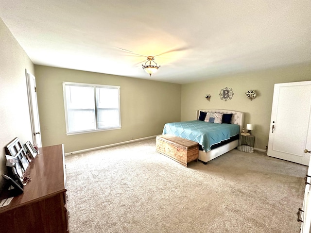 bedroom featuring light carpet