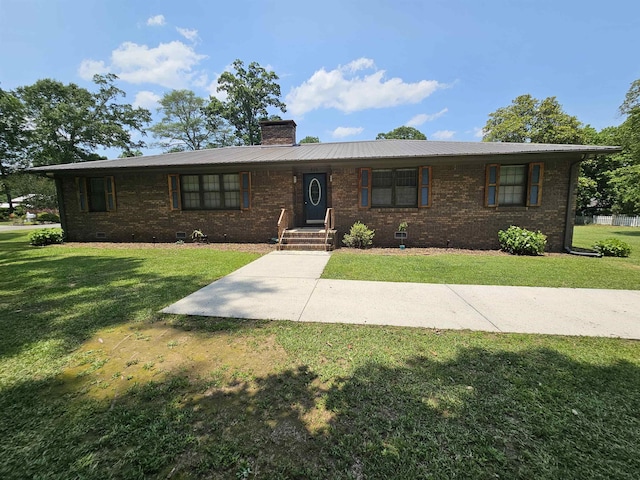 - ranch-style house with a front lawn, a chimney, brick siding, and crawl space