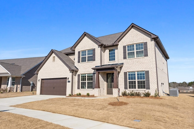 view of front of property with a garage and a front lawn