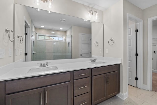 bathroom with tile patterned floors, vanity, and a shower with door