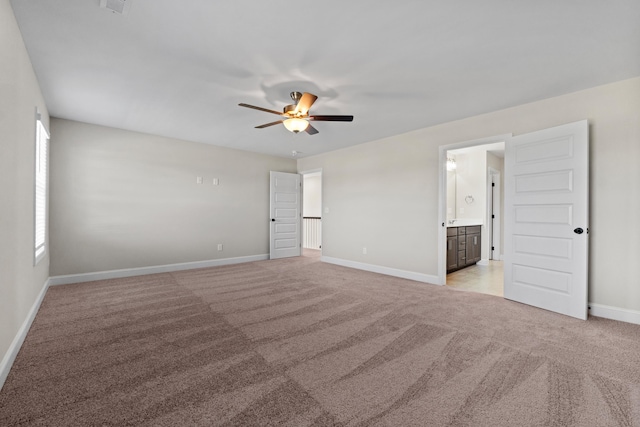 empty room featuring light colored carpet and ceiling fan