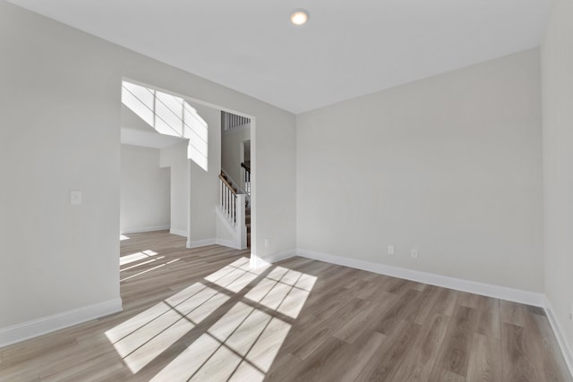 empty room with light hardwood / wood-style flooring