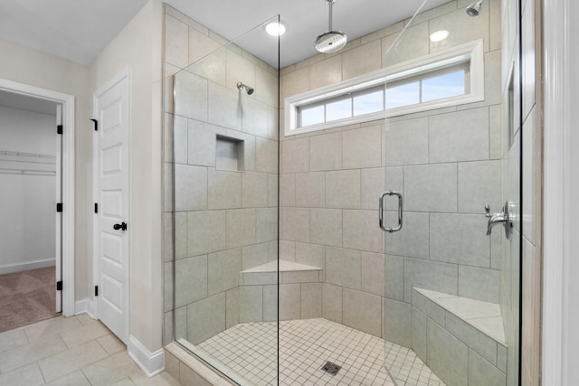 bathroom featuring tile patterned flooring and an enclosed shower