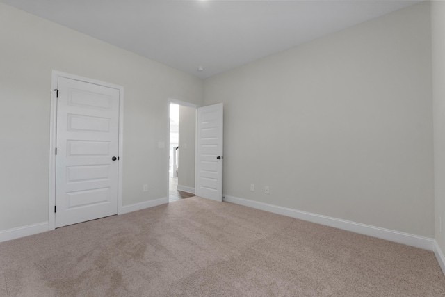 empty room featuring light colored carpet