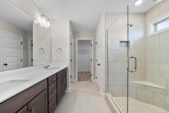 bathroom with tile patterned floors, vanity, and an enclosed shower