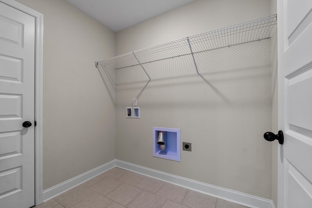 clothes washing area with light tile patterned floors, washer hookup, and hookup for an electric dryer