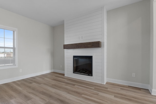 unfurnished living room featuring light hardwood / wood-style floors and a fireplace