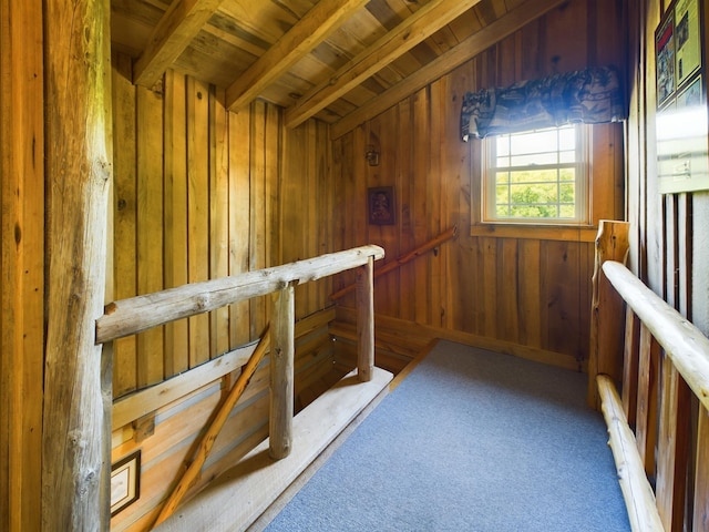 bonus room with lofted ceiling with beams, wooden walls, wood ceiling, and light carpet